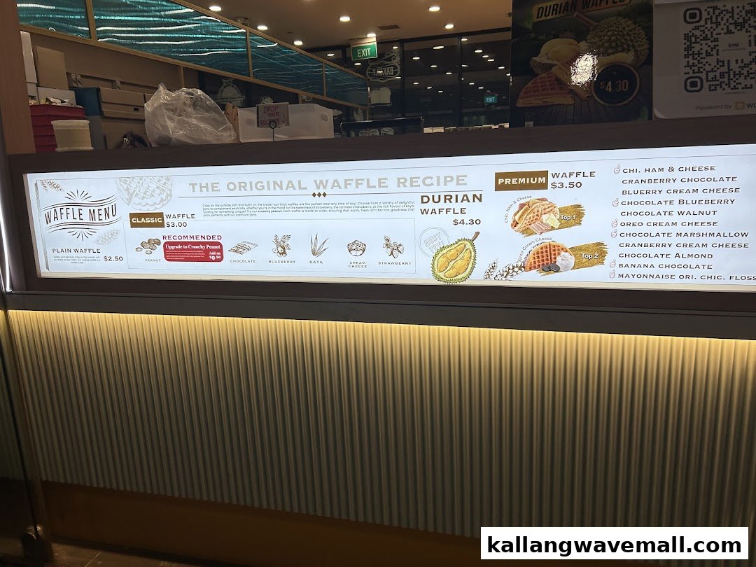 A brightly lit menu board displaying various waffle options and prices at a dessert shop.