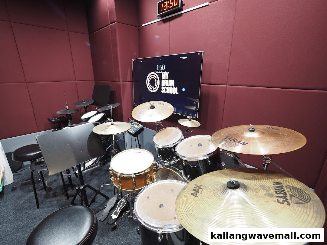 An interior shot of My Drum School Kallang, featuring multiple drum kits in a soundproofed practice room.