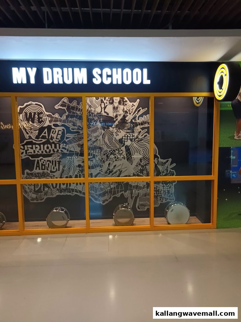 The storefront of My Drum School, featuring a large window display with drums and artistic graphics.