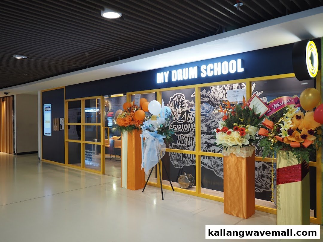 The vibrant exterior of 'My Drum School' with festive floral arrangements and balloons.