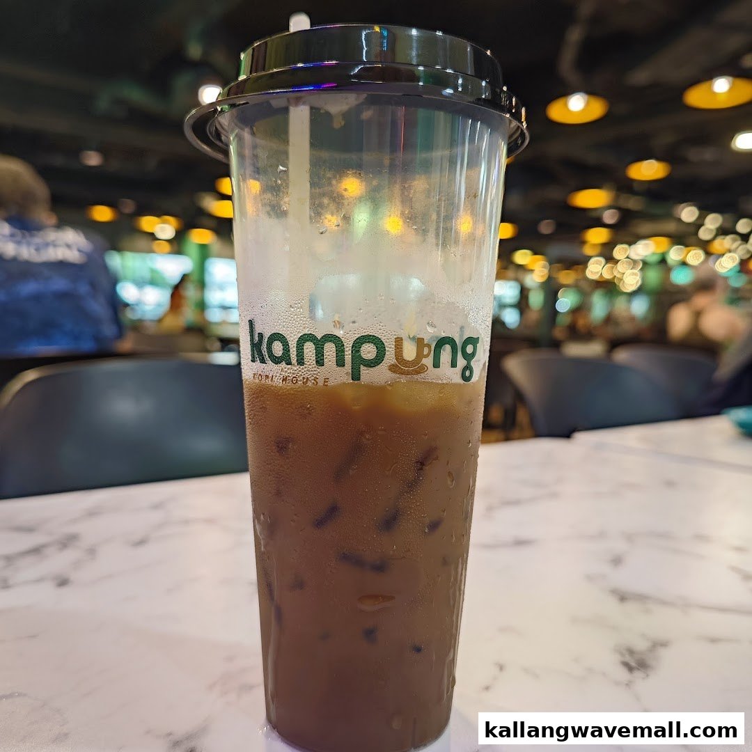 A refreshing iced beverage from My Kampung, with the shop's interior visible in the background.