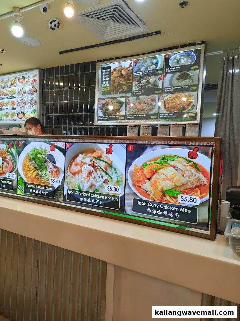 A vibrant display board showcasing various Malaysian noodle dishes and local delights with prices at My Kampung.
