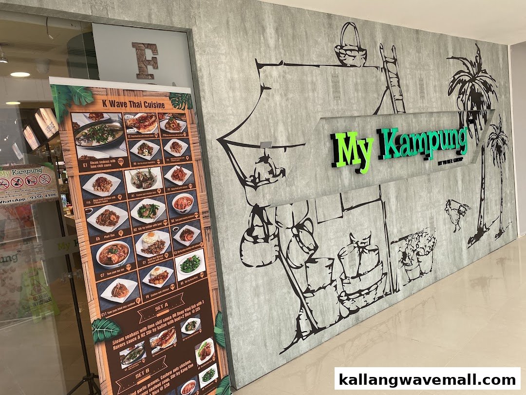 The entrance of My Kampung restaurant, featuring its green signage and a large menu banner for K Wave Thai Cuisine.