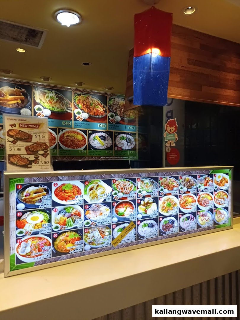 Illuminated menu boards showcasing a variety of Korean dishes and prices at My Kampung.