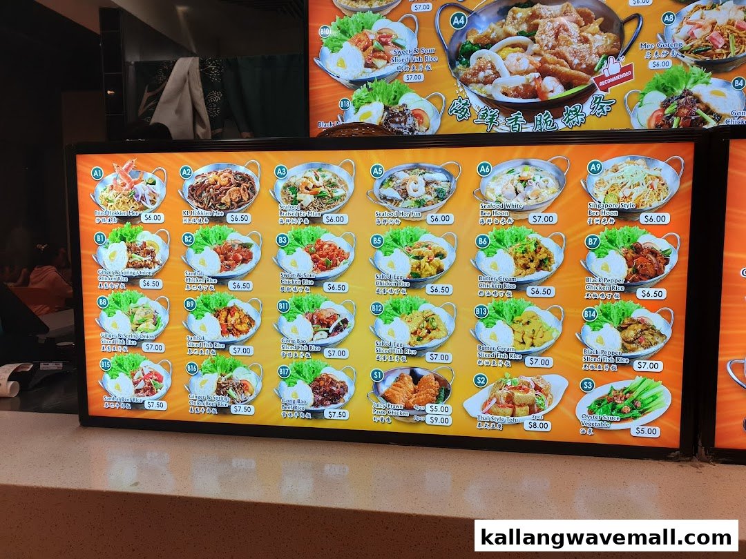 A brightly lit menu board showcasing a variety of Asian noodle, rice, and side dishes.