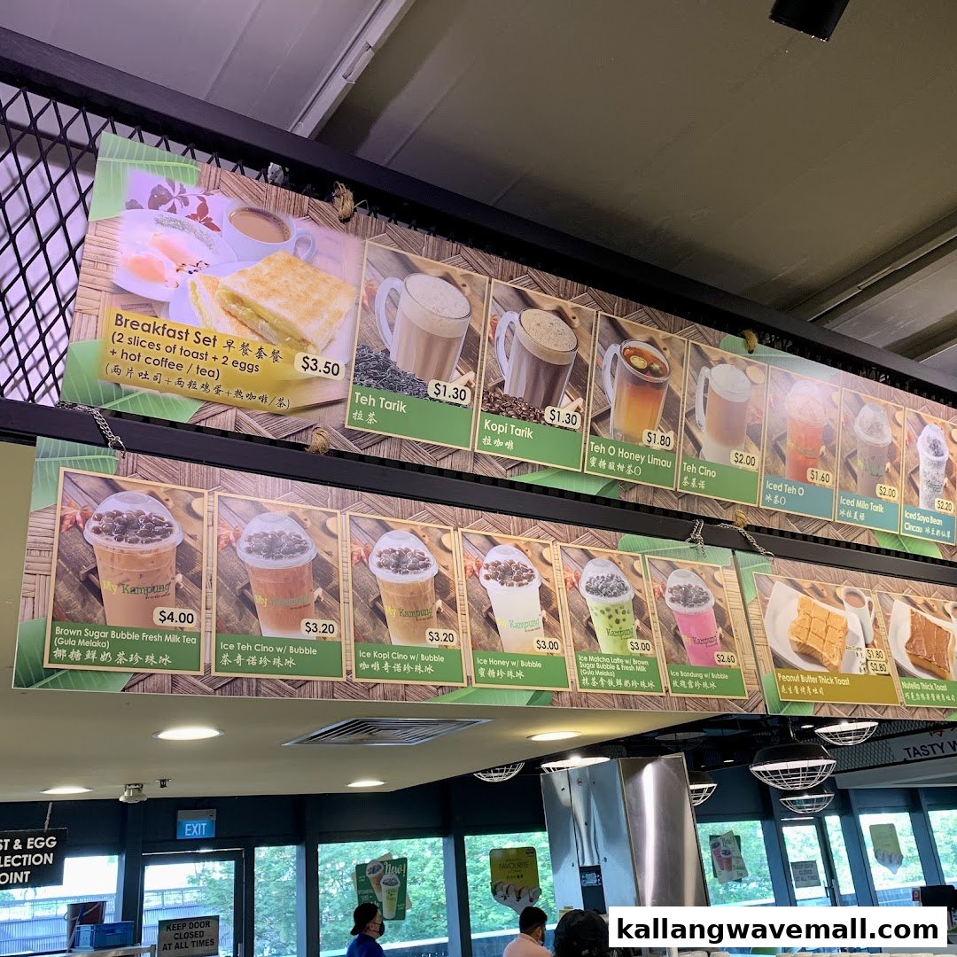 A large menu board displaying breakfast sets, traditional drinks, bubble teas, and toasts with prices at My Kampung.