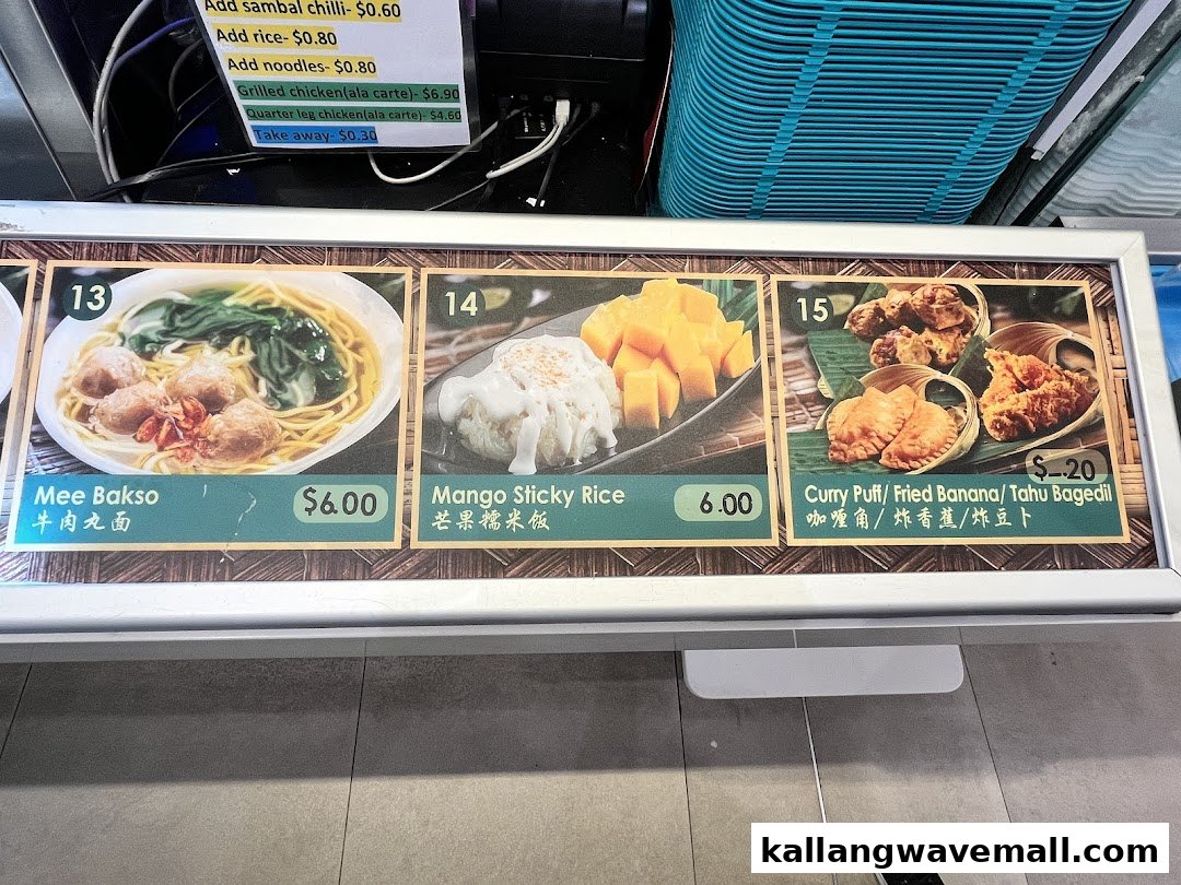A vibrant display board showcasing popular dishes and prices from My Kampung, including Mee Bakso and Mango Sticky Rice.