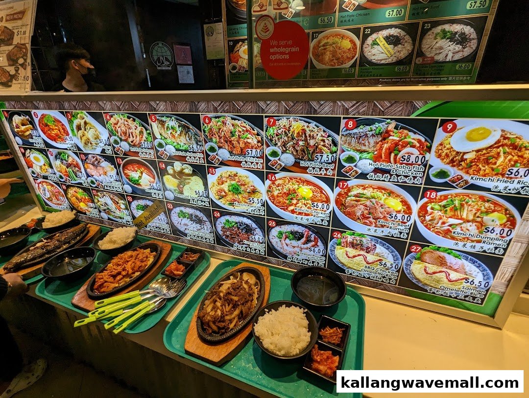 A vibrant display of Korean and Asian dishes on a digital menu board with prepared food on the counter.