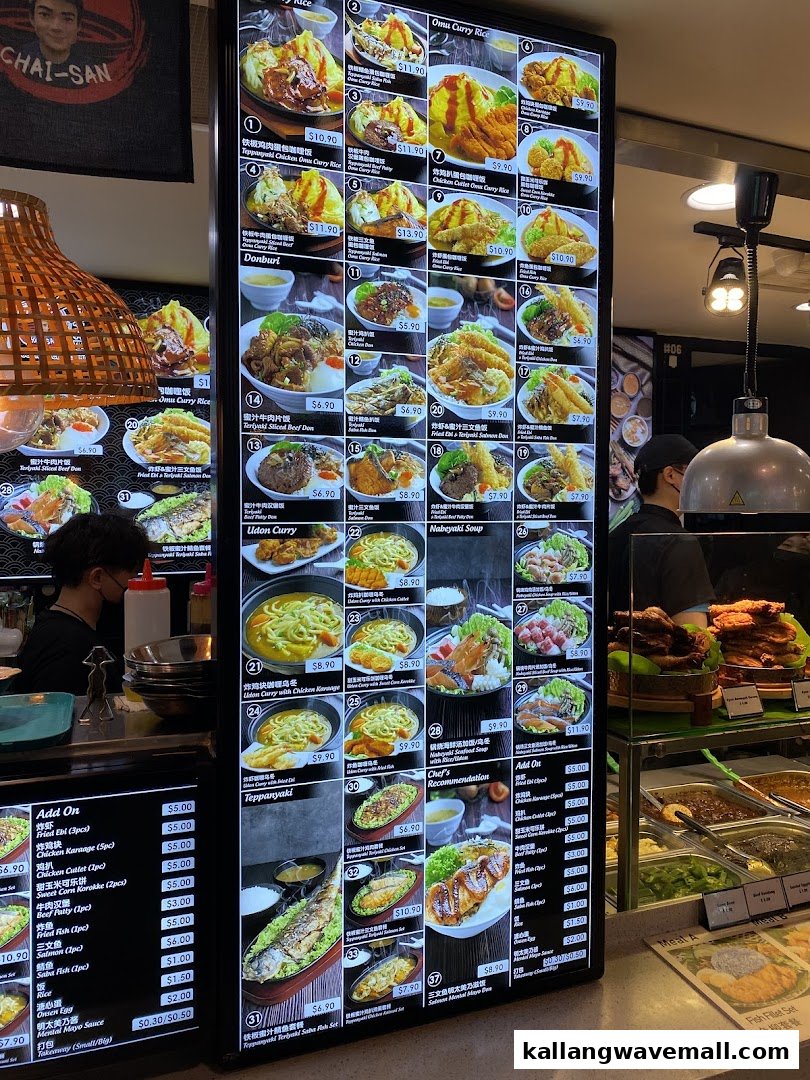 A brightly lit digital menu board displaying a wide variety of Japanese and Asian dishes with prices.