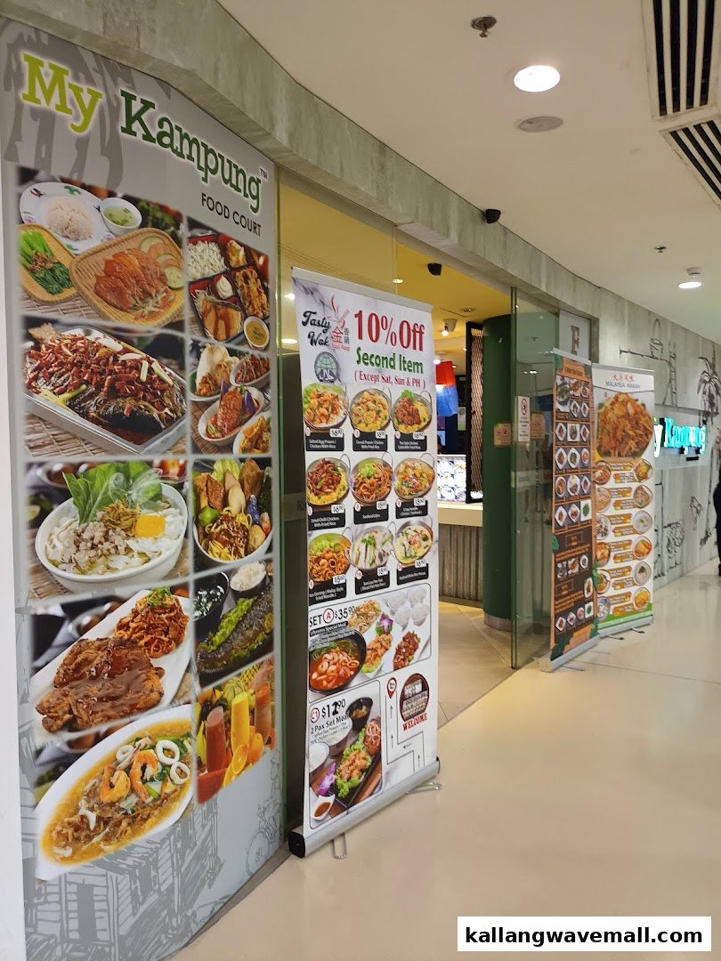 The vibrant entrance of My Kampung Food Court, showcasing diverse food options and promotional banners.