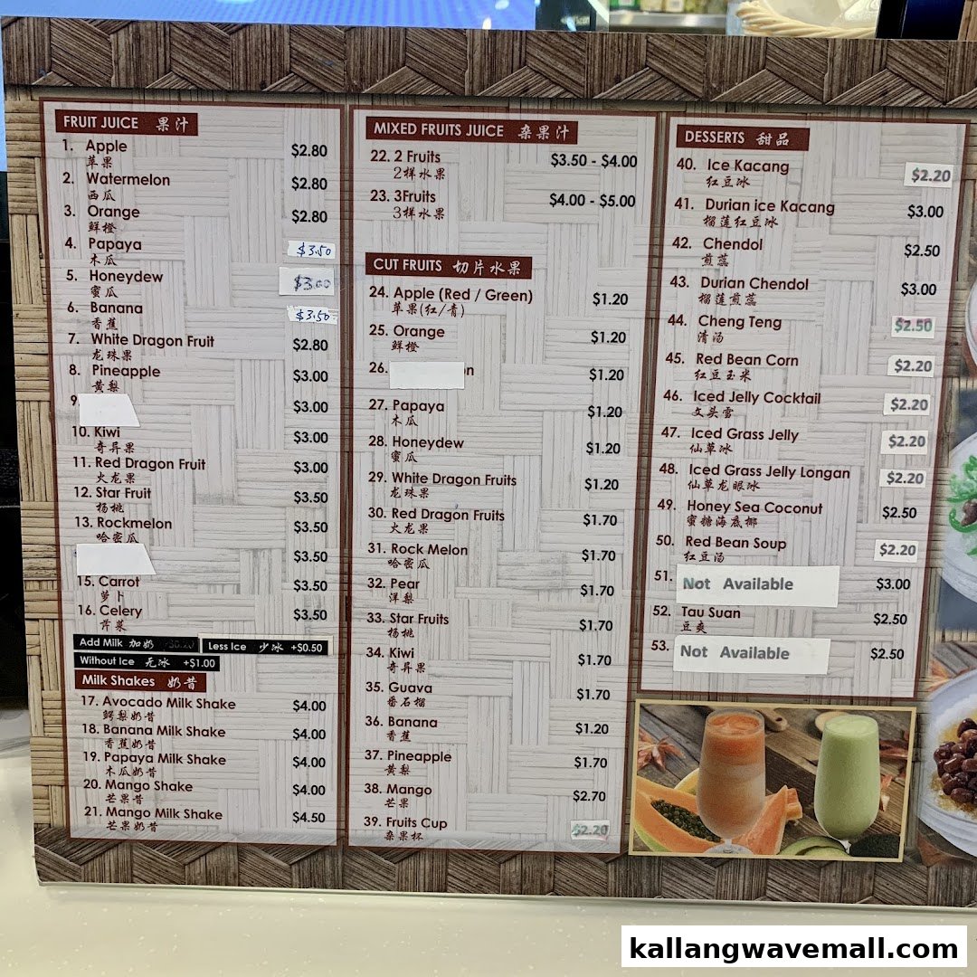 A detailed menu board displaying various fruit juices, mixed fruits, cut fruits, desserts, and milkshakes with prices.