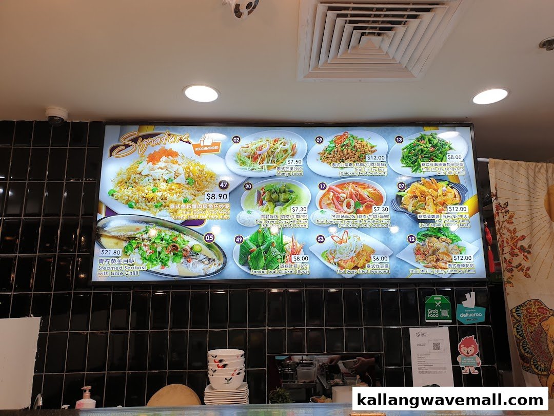 A vibrant digital menu board displaying various Thai dishes with images and prices.