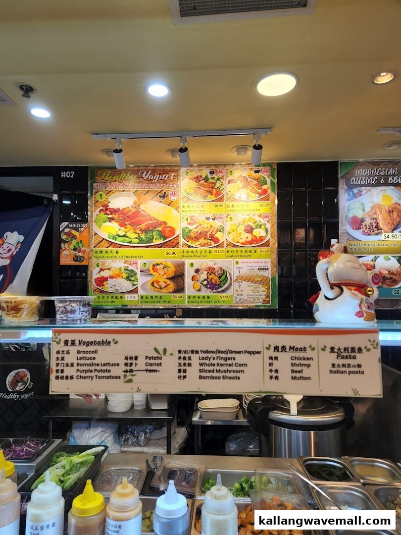 A vibrant display of menu boards for healthy yogurt and Indonesian cuisine, with fresh ingredients visible at the counter.