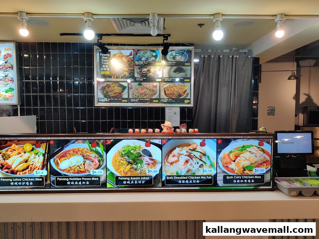 A vibrant display of Malaysian noodle dishes with prices at My Kampung food stall.