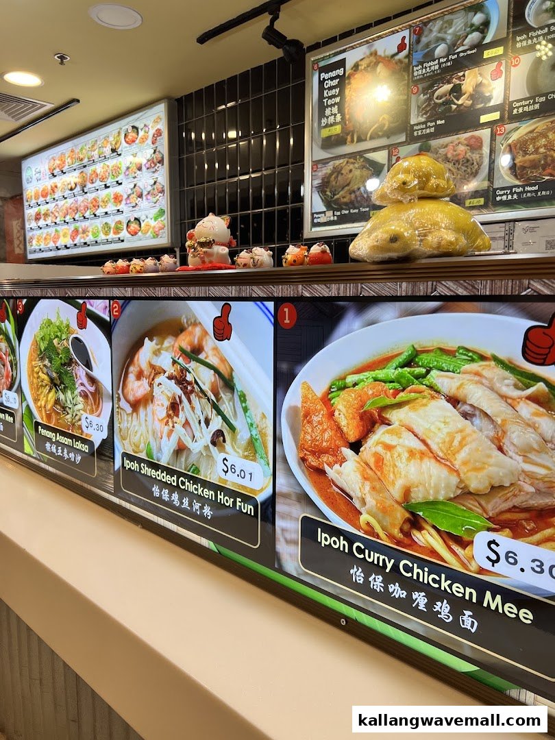 Digital menu boards displaying various Malaysian dishes with prices and decorative items at My Kampung.