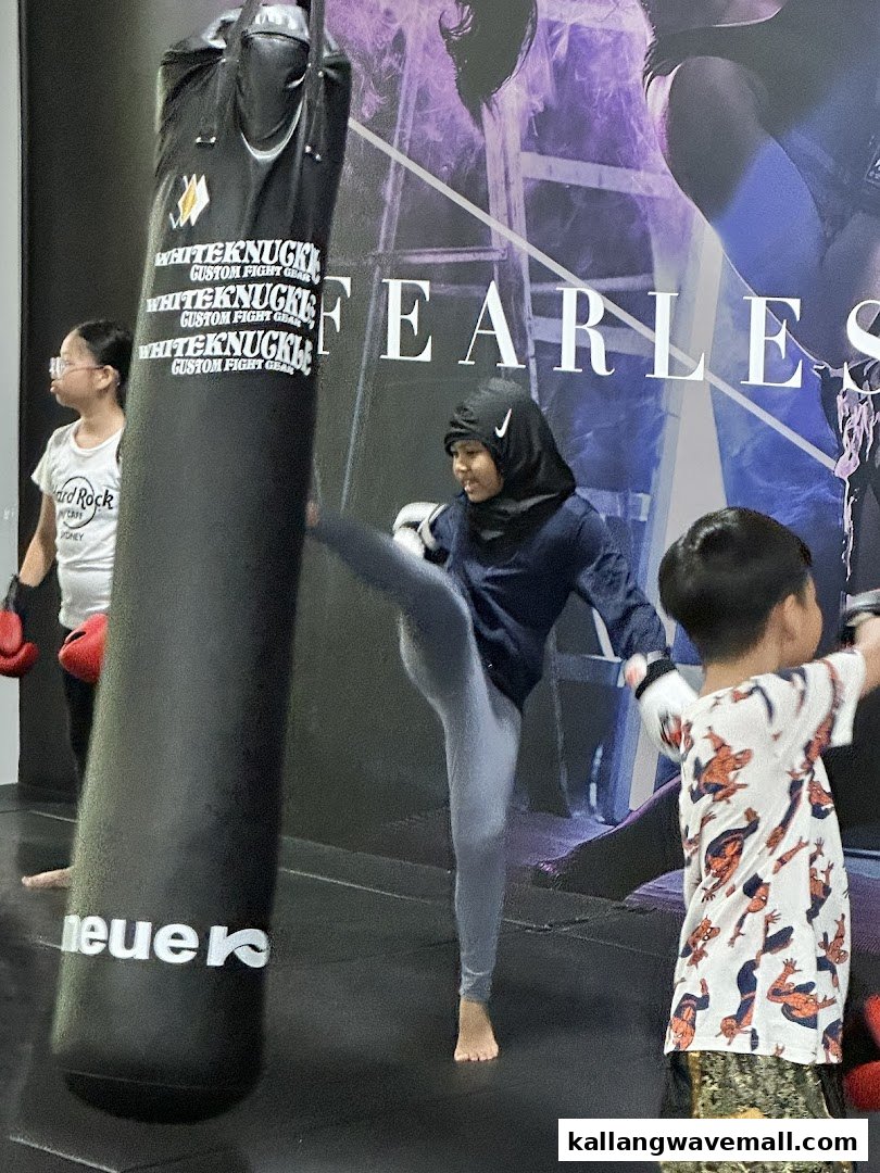 People training with a punching bag at Neue Fit, a dynamic fitness center.