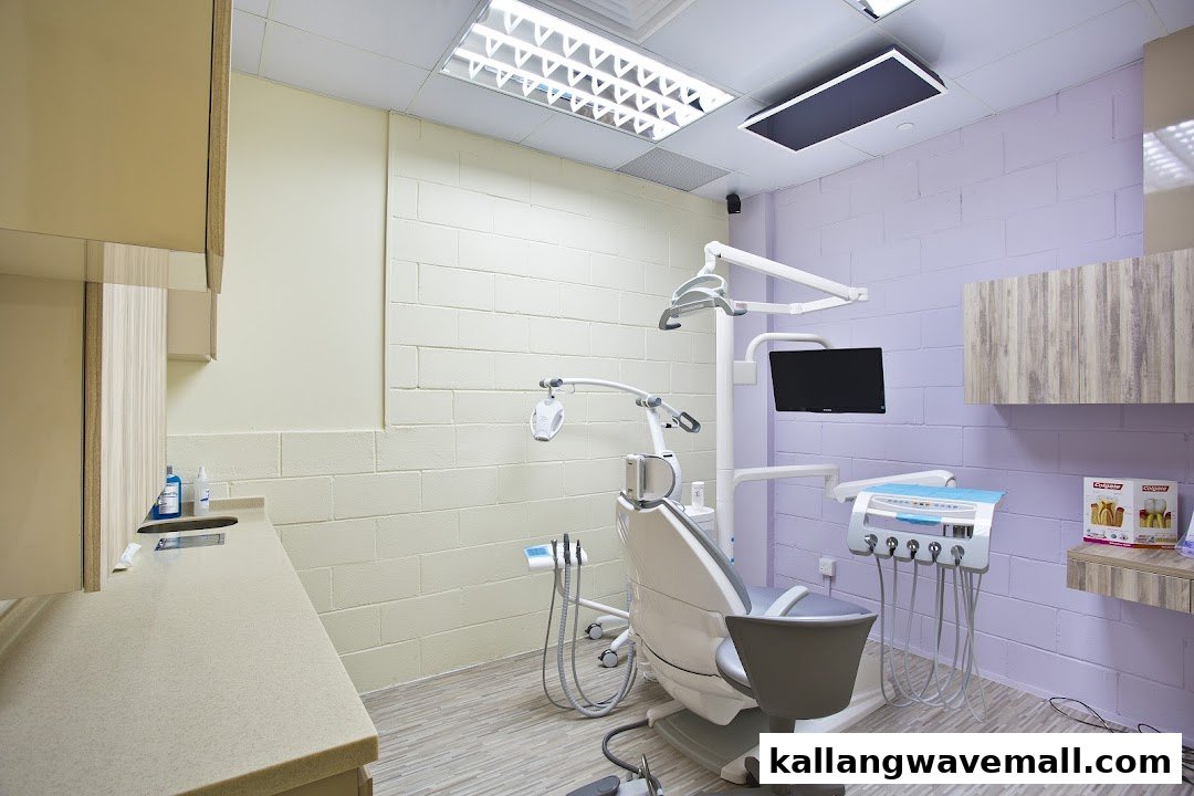 A modern dental treatment room with a chair and equipment, featuring light purple and beige walls.