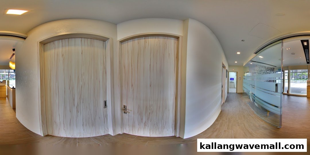 A panoramic view of a modern dental clinic interior featuring light wood doors and frosted glass partitions.