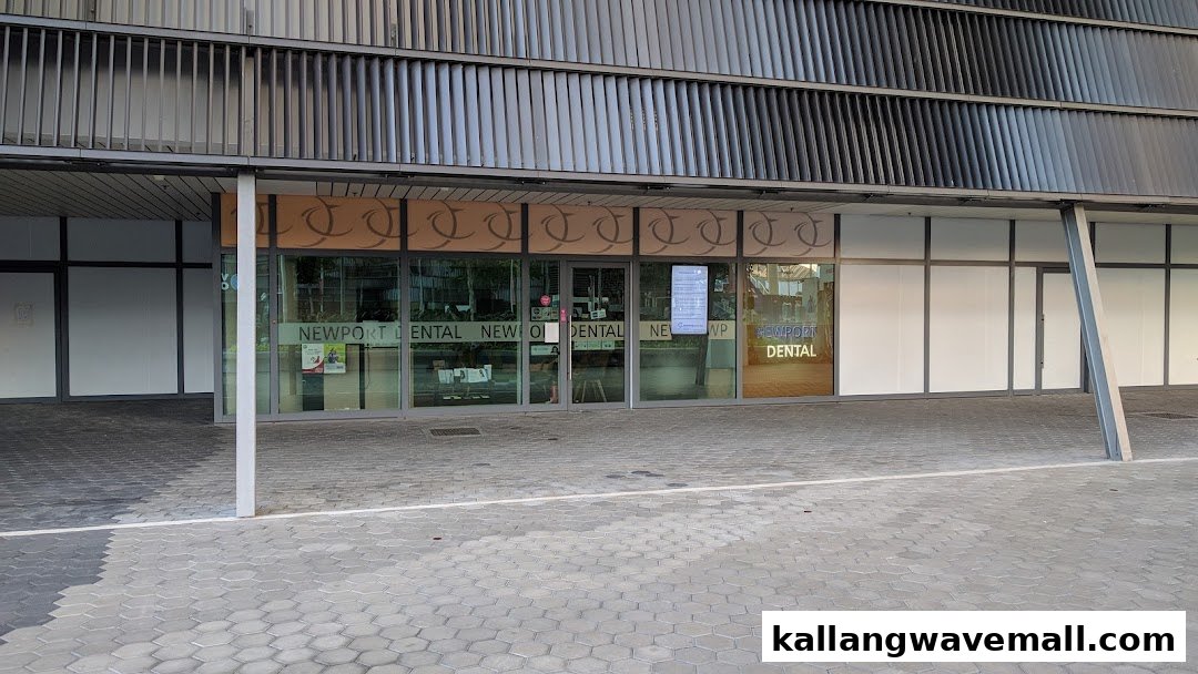 Exterior view of Newport Dental clinic with a modern glass entrance and building facade.