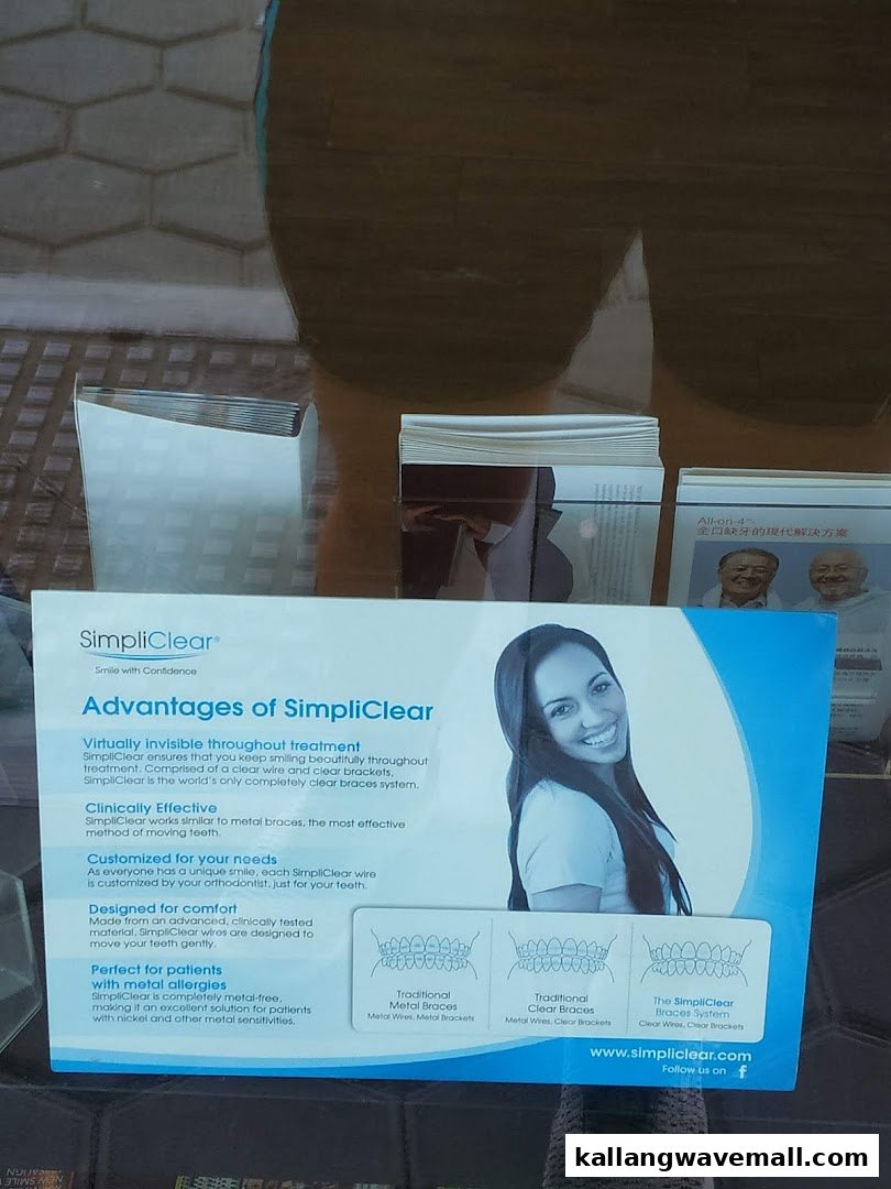 An informational display poster for SimpliClear braces, visible through a glass surface.