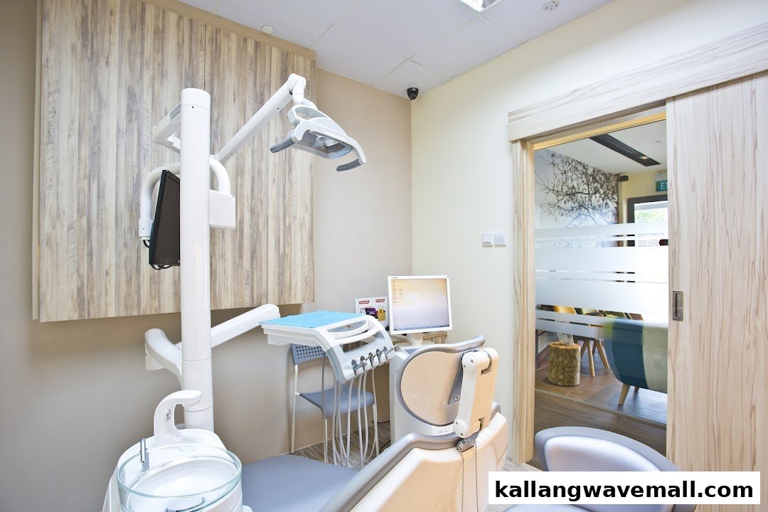 A modern dental treatment room with a patient chair, equipment, and a wooden accent wall.