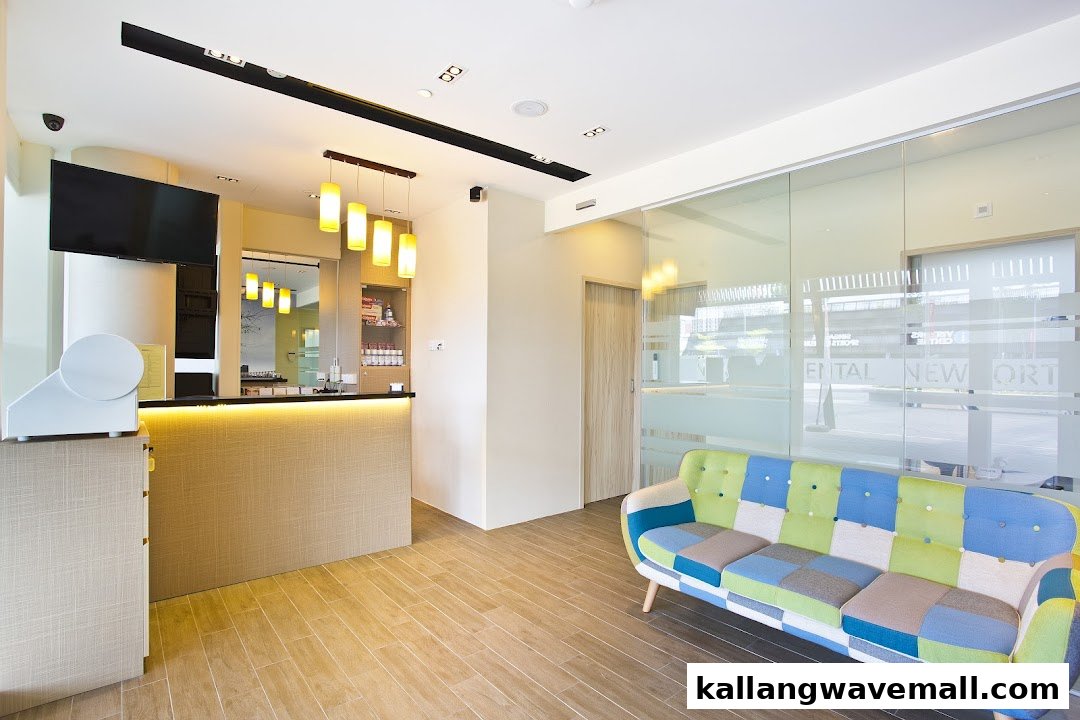 A bright, modern dental reception area featuring a colorful patchwork sofa and a sleek front desk.