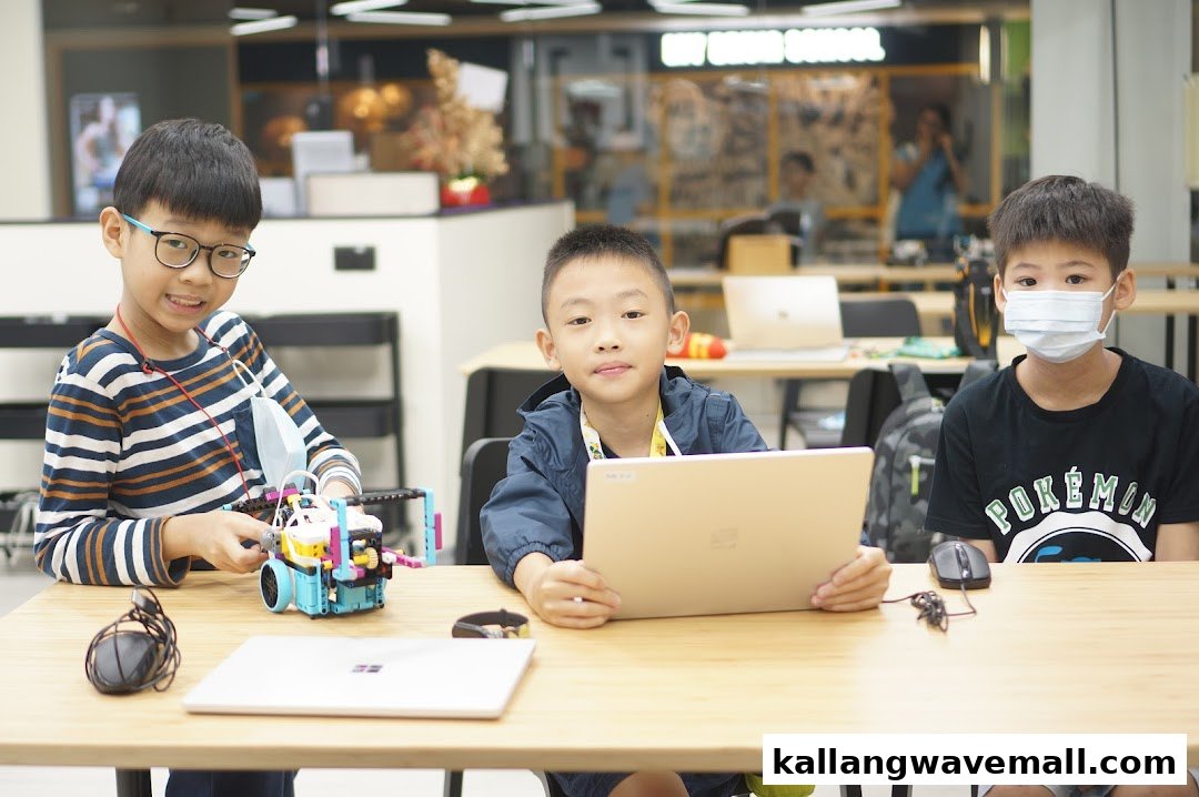 Three boys engaged in robotics and tech activities at Nullspace Robotics.