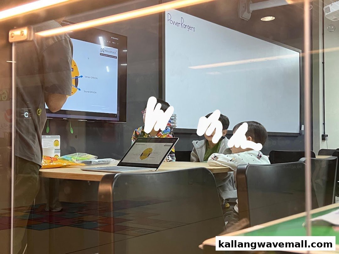 Children and an instructor engaged in a robotics class inside Nullspace Robotics.