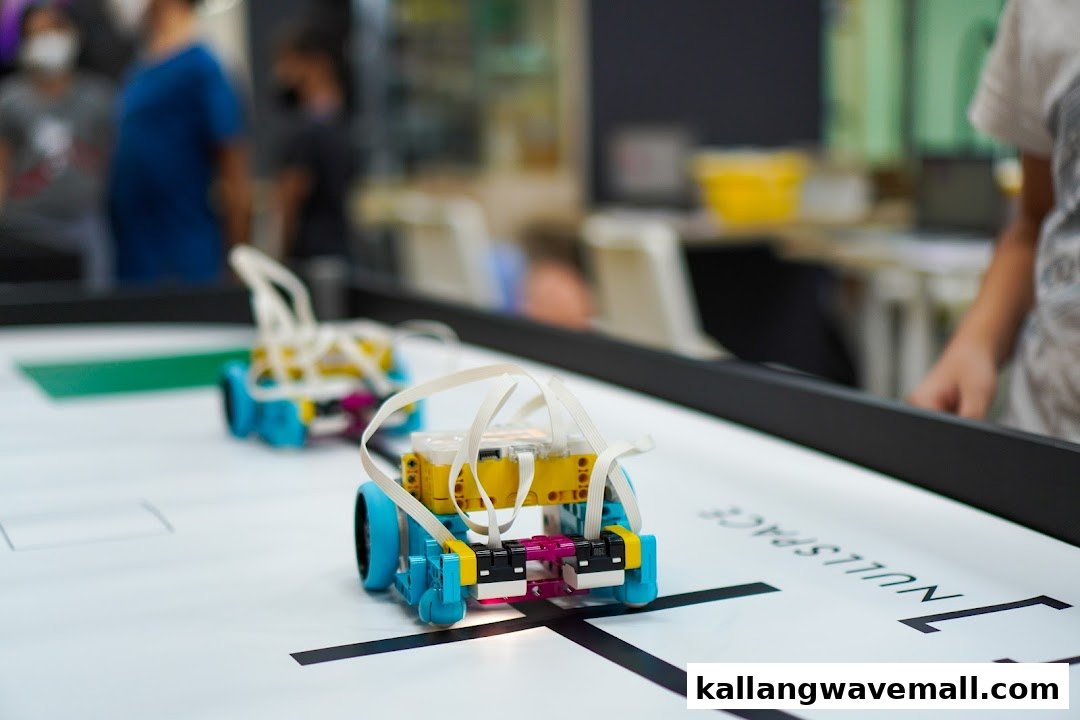 Two small, colorful robots on a white track with 'NULLSPACE' branding, demonstrating robotics in action.