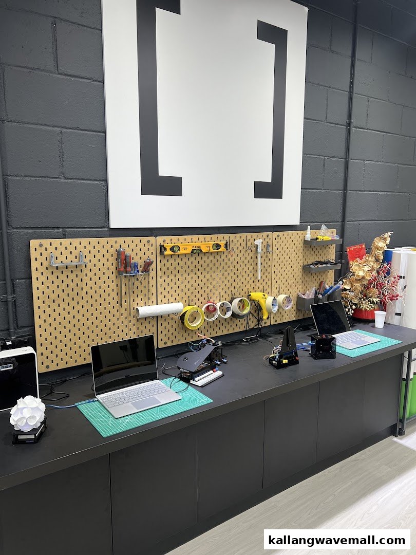 A robotics workshop featuring laptops, tools, and various projects on a workbench.