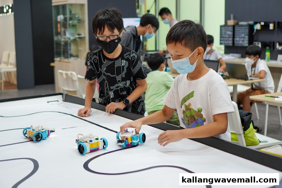 Children wearing masks engaging with robots on a track at Nullspace Robotics.