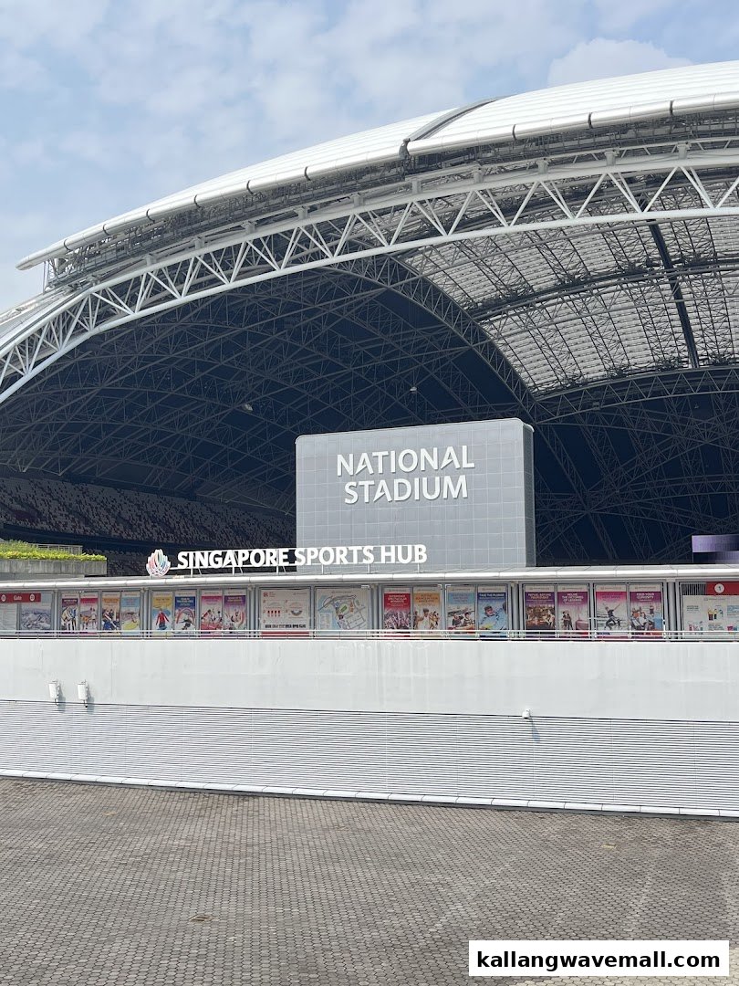 The iconic Singapore National Stadium and Sports Hub exterior under a clear sky.