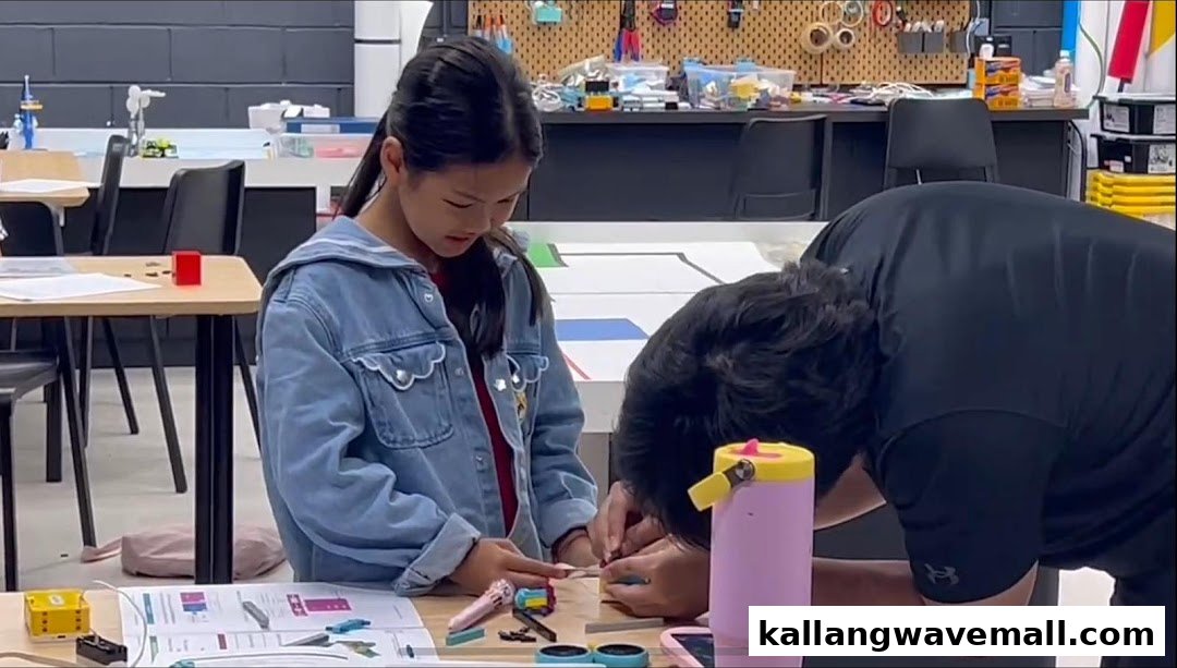 A girl and an instructor are engaged in a hands-on robotics building activity at Nullspace Robotics.
