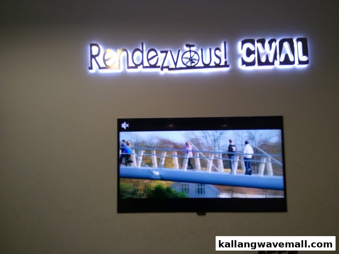 An interior wall featuring a lighted 'Rendezvous! CWAL' sign and a TV screen displaying outdoor activity.