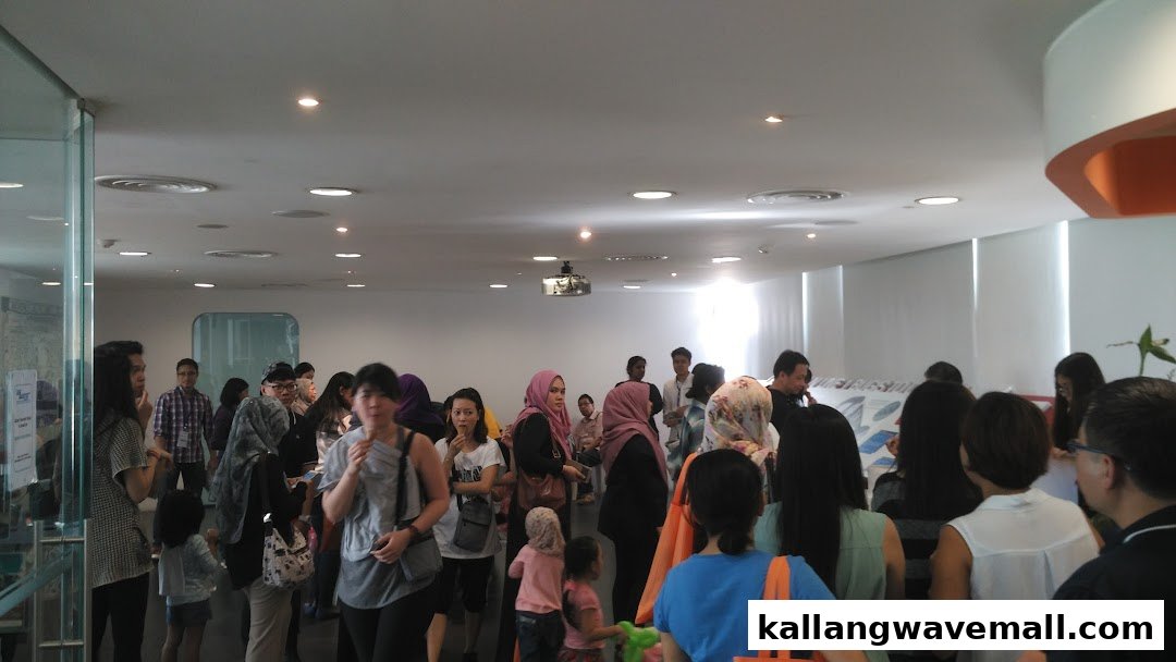 A bustling indoor scene with many people, likely guests awaiting their O-Ride Segway tour.