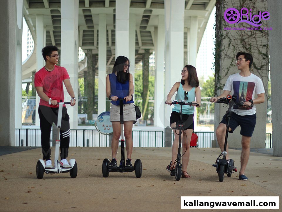 Four people enjoy riding mini Segways and electric scooters outdoors, showcasing the tour experience.