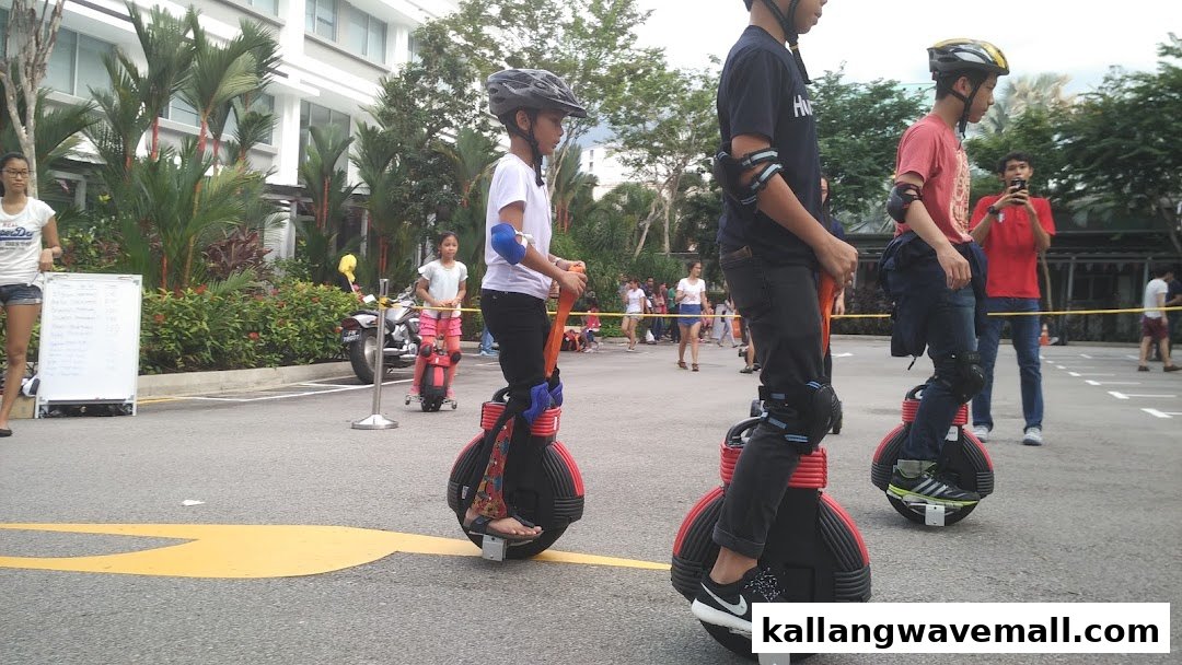 People of various ages enjoy riding electric unicycles outdoors, showcasing a unique tour experience.
