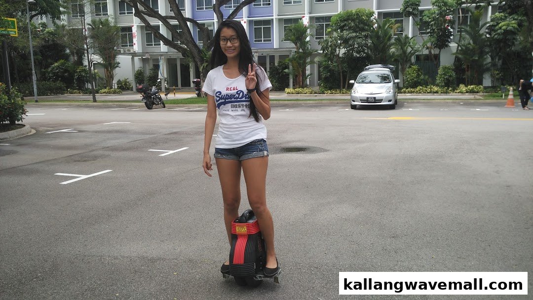 A person stands on a mini segway-like device in an outdoor area, showcasing the tour experience.