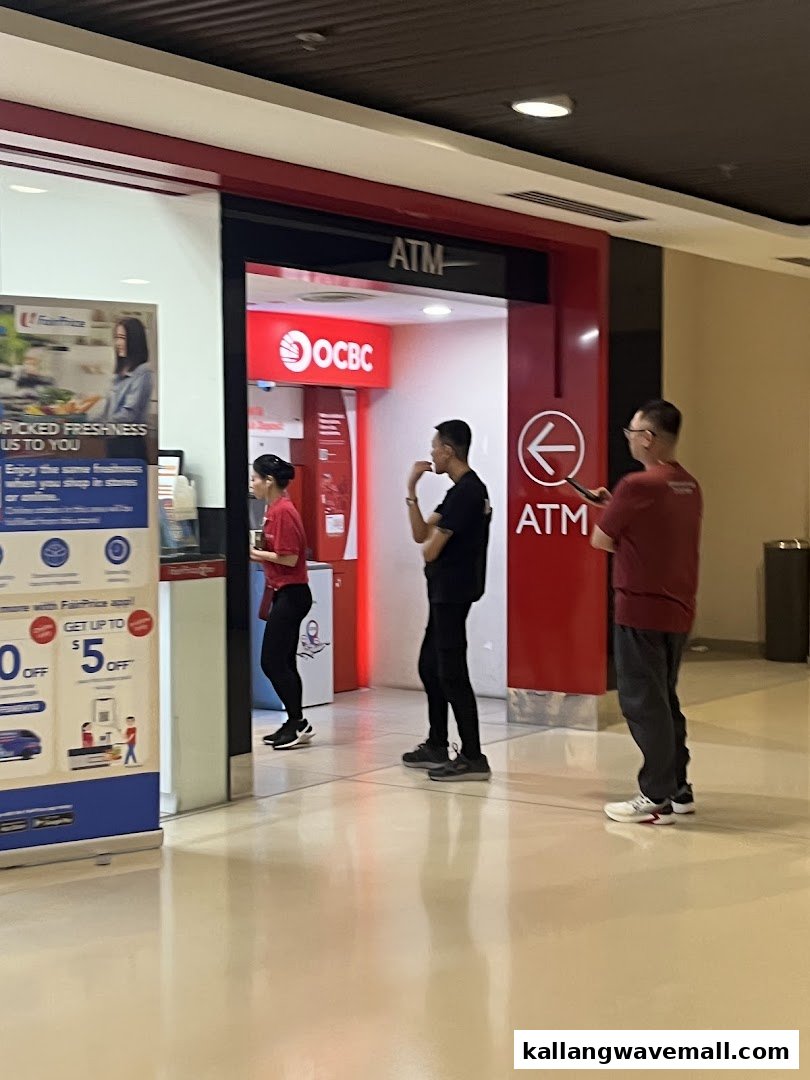 People are seen using the OCBC ATM for banking services within the mall.