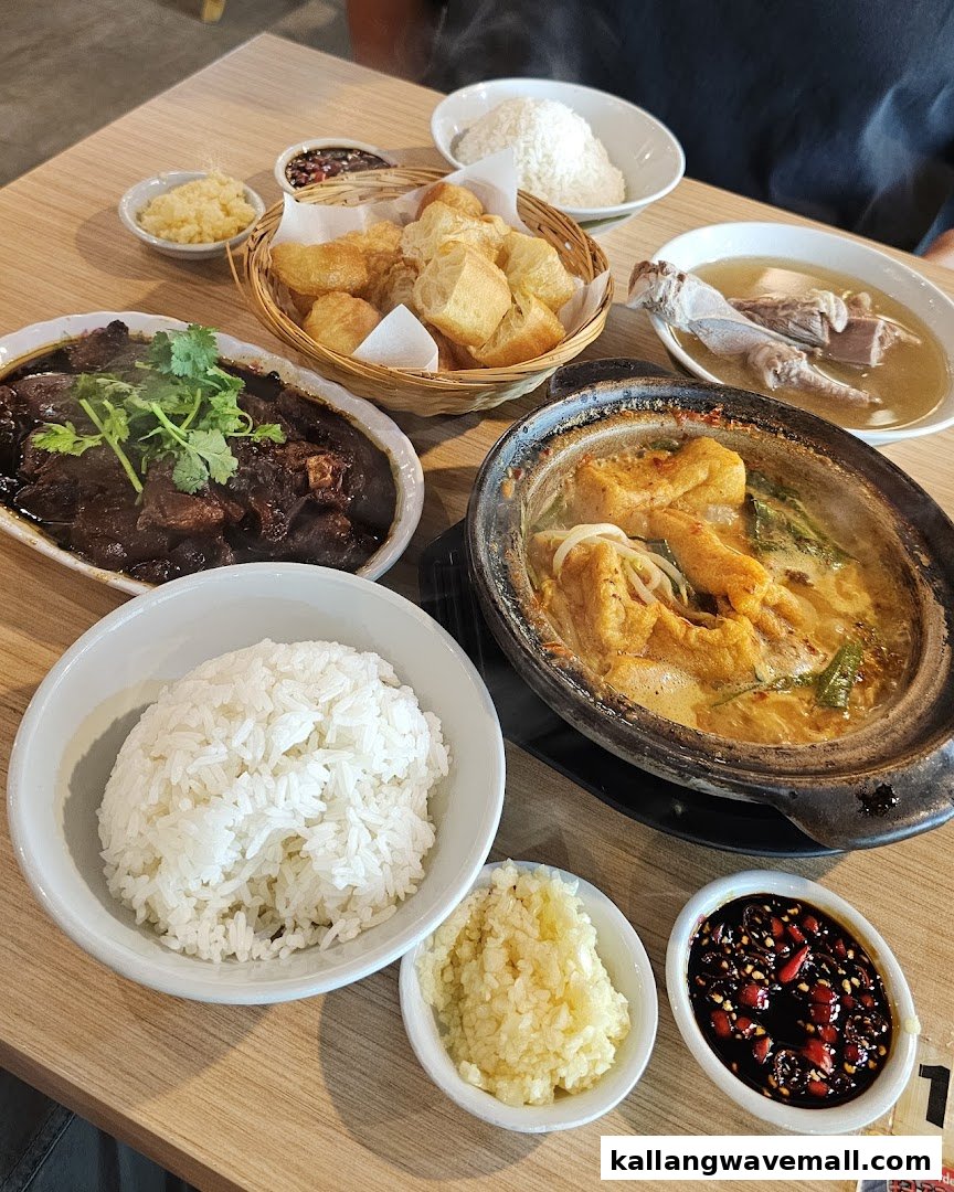 A table laden with various delicious dishes, including Bak Kut Teh, rice, and side dishes.