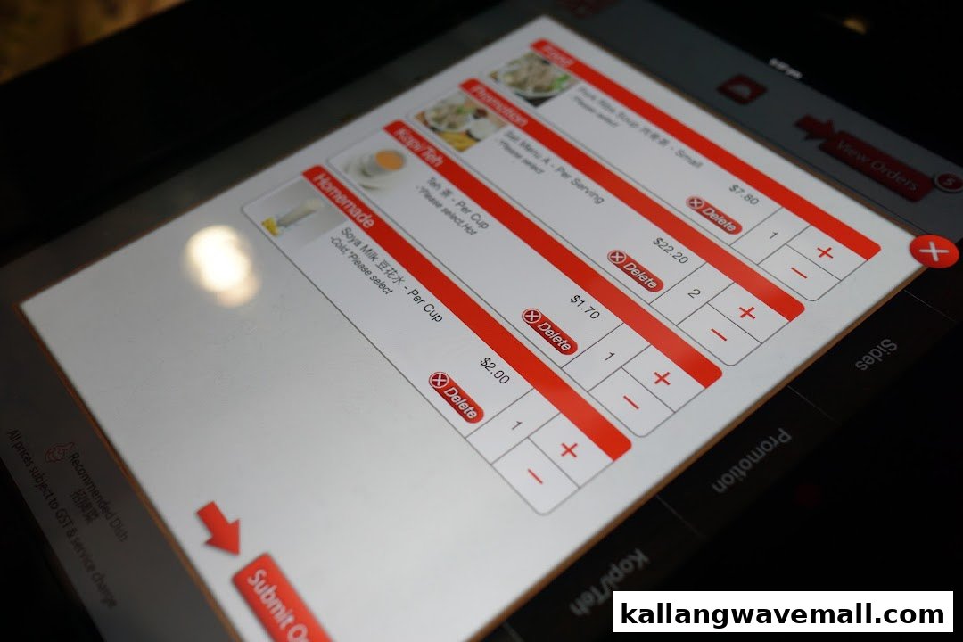 A close-up of a digital ordering tablet displaying menu items, prices, and quantity selectors.