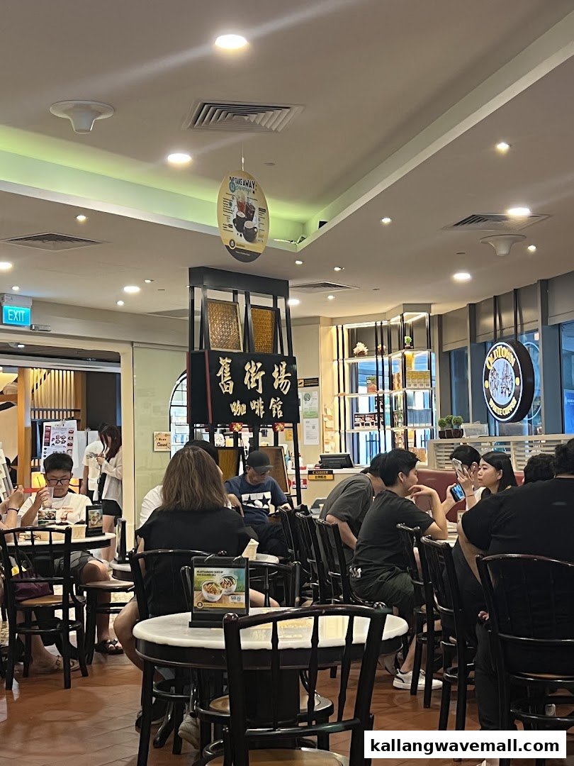Customers enjoying meals and drinks inside Oldtown White Coffee, showcasing the shop's interior and ambiance.