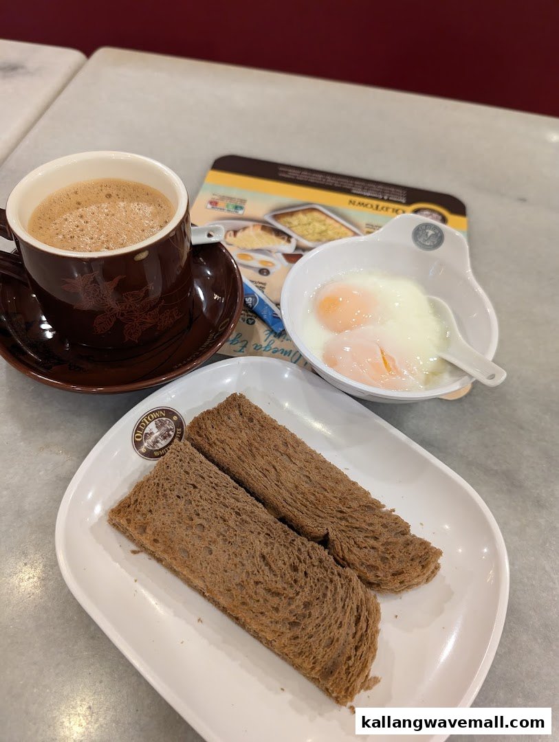 A classic Oldtown White Coffee breakfast set with coffee, soft-boiled eggs, and toast.