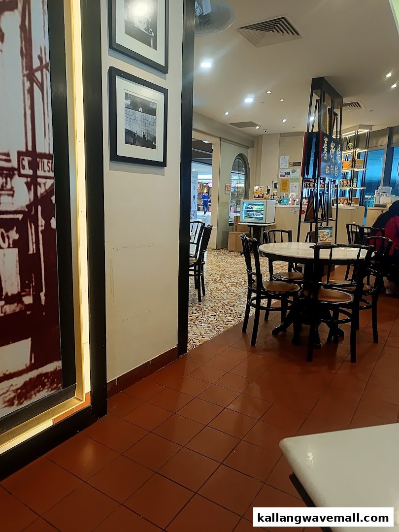 Interior view of Oldtown White Coffee showing dining area with tables and chairs.