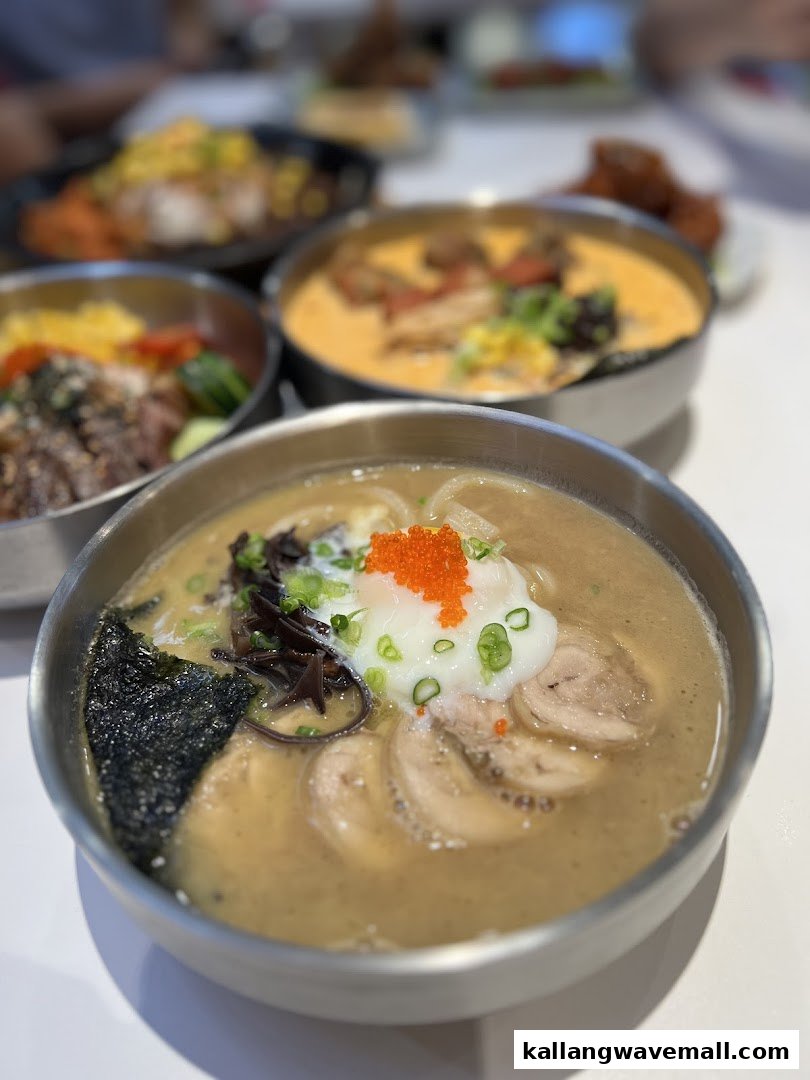 A close-up of a delicious ramen bowl with other Korean-inspired dishes in the background.