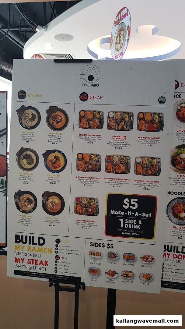 A large menu board displaying various ramen, steak sets, and side dishes with prices.