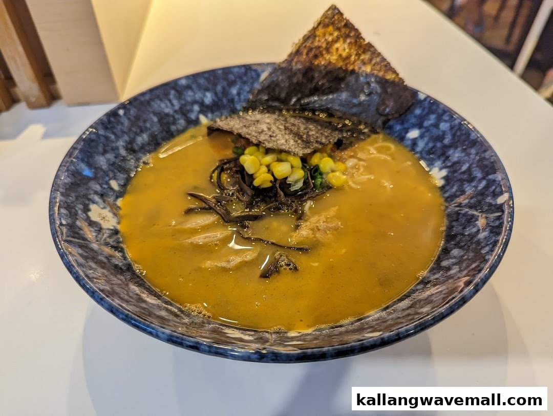 A close-up of a delicious bowl of ramen with corn, seaweed, and mushrooms.