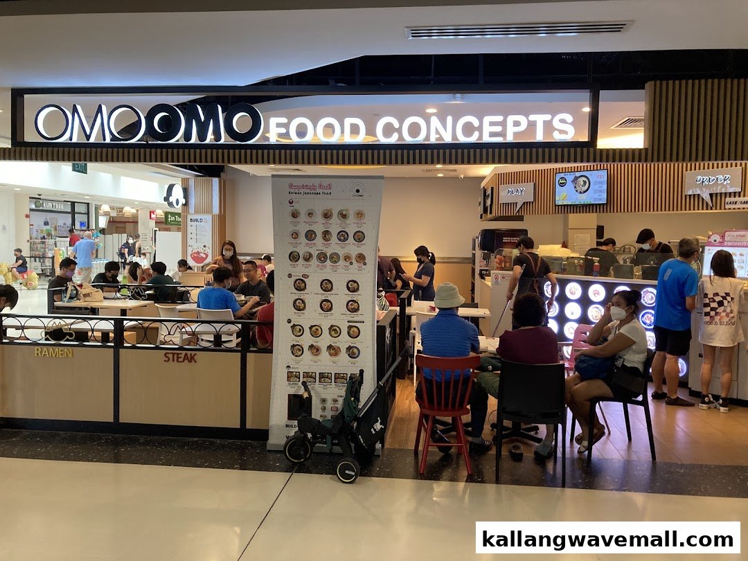 Customers dine inside OMOOMO Food Concepts, a Korean Japanese eatery with a vibrant atmosphere.