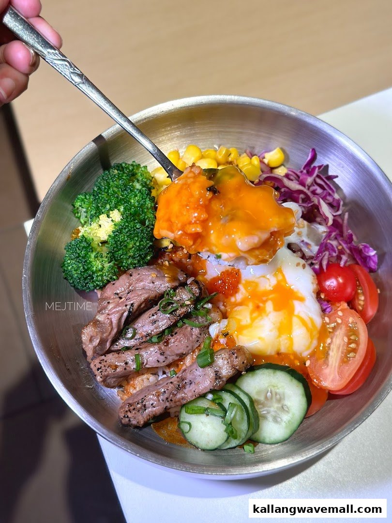 A vibrant rice bowl featuring sliced steak, a poached egg, and fresh vegetables, being served with a spoon.