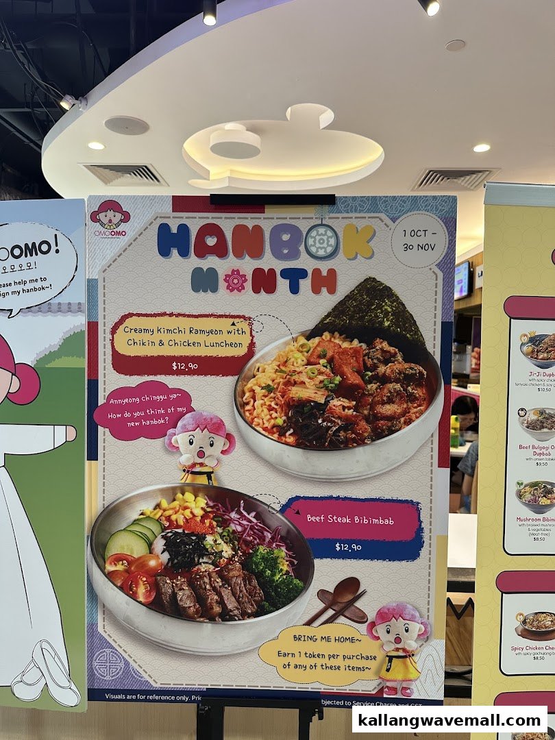 A promotional stand for OMOOMO featuring Korean dishes like Kimchi Ramyeon and Beef Steak Bibimbab.